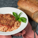 Bowl of pasta with oil-free marinara and loaf of multi-grain bread
