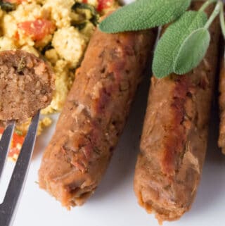 Breakfast Sausage Links with tofu scramble, and a fork with bite of sausage