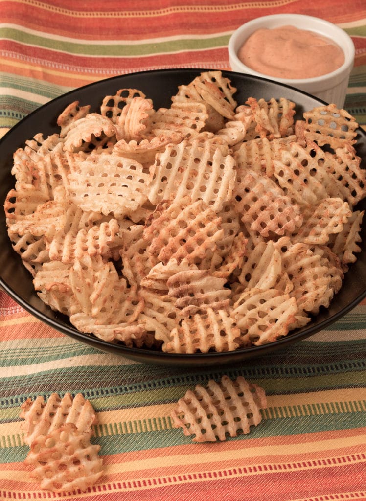 Bowl of Seasoned Waffle Fries with dipping sauce
