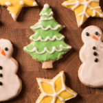 Cutting board with Oil-free Vegan Sugar Cookies decorated for Christmas