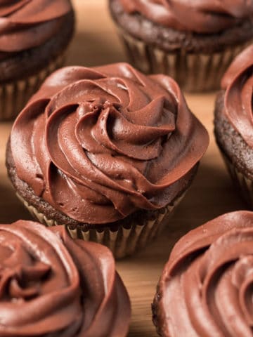 Picture of seven chocolate cupcakes on wooden tray