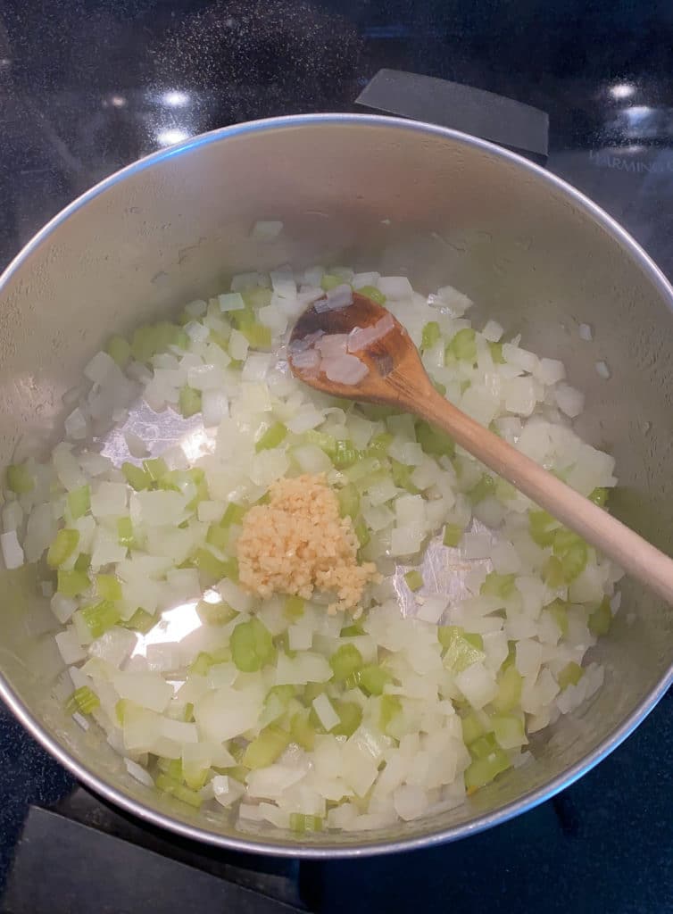 Garlic added to pot of onions and celery