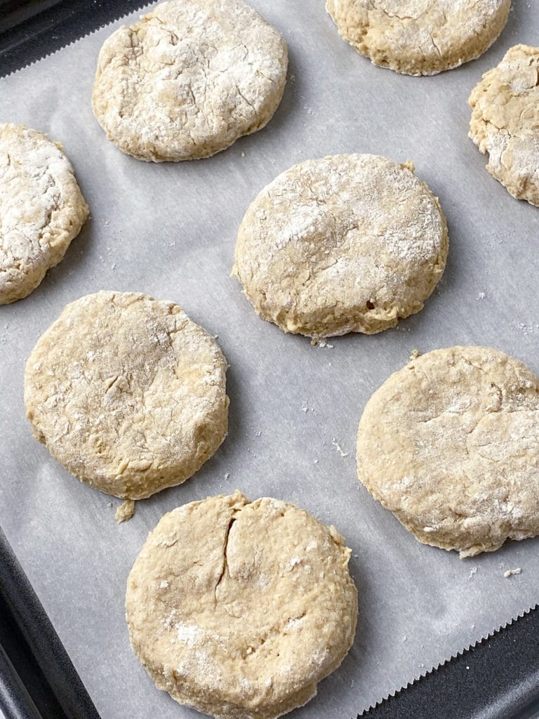 Unbaked biscuits on parchment lined baking sheet