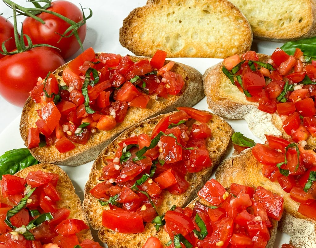 Closeup of tomato basil topping on bruschetta