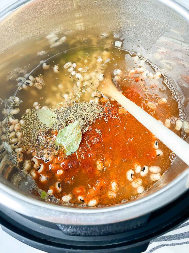 Black eyed peas, broth, and seasonings in Instant Pot