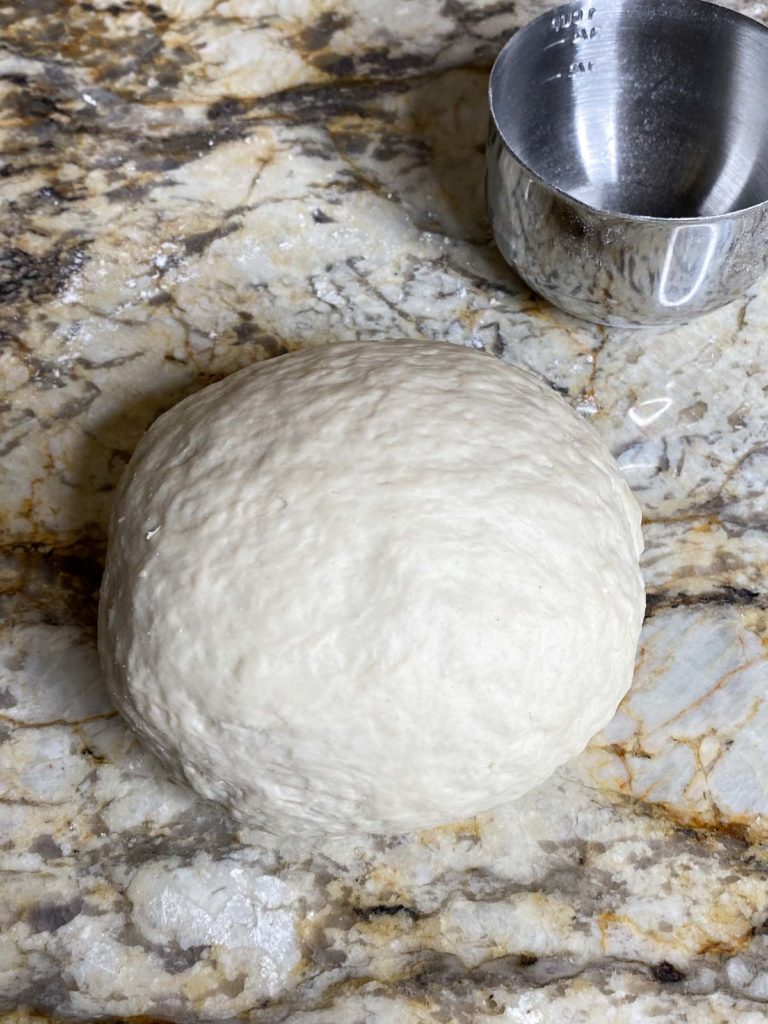 Ball of flour tortilla dough on counter