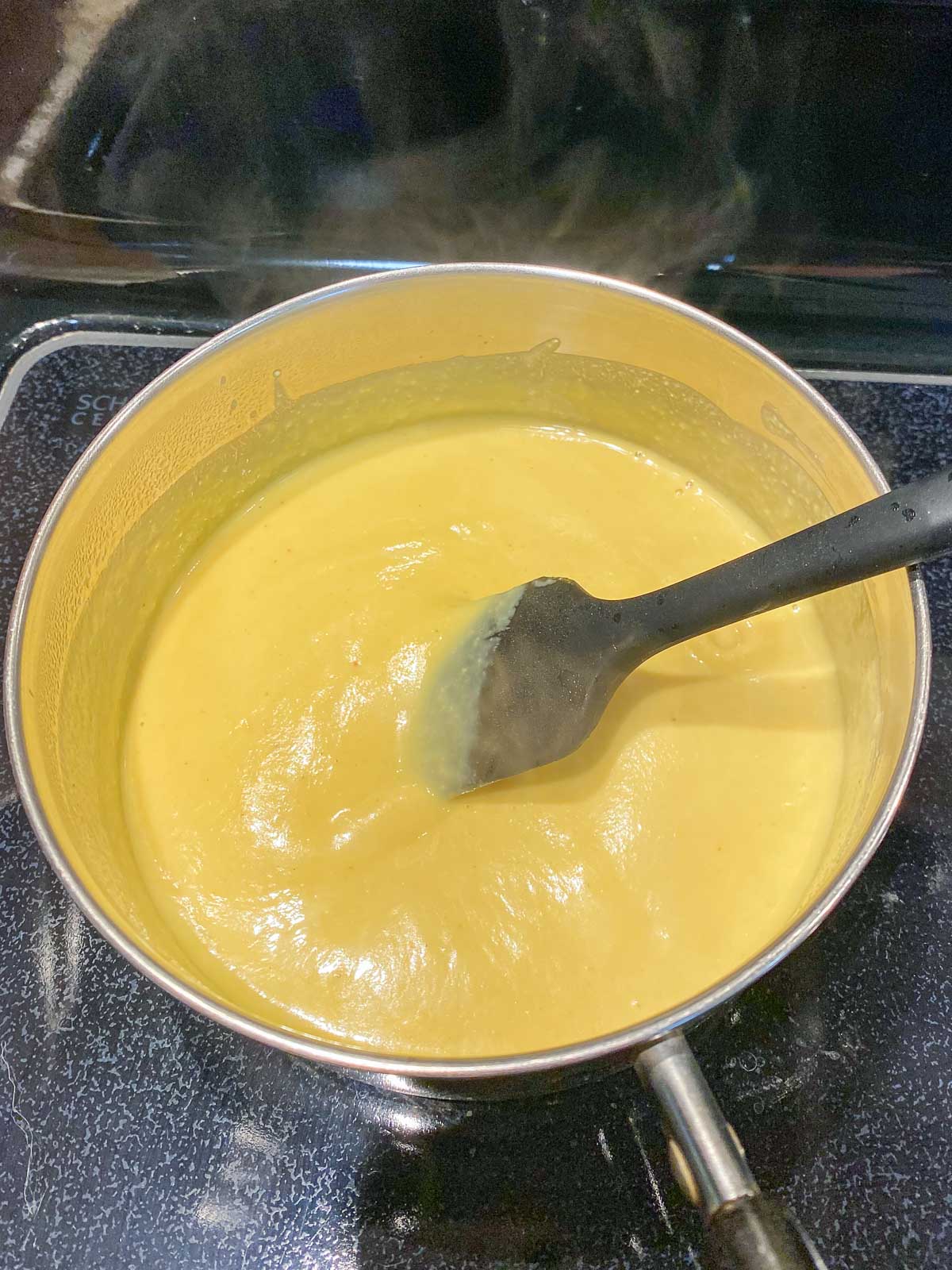 Cooked hollandaise sauce in sauce pan.