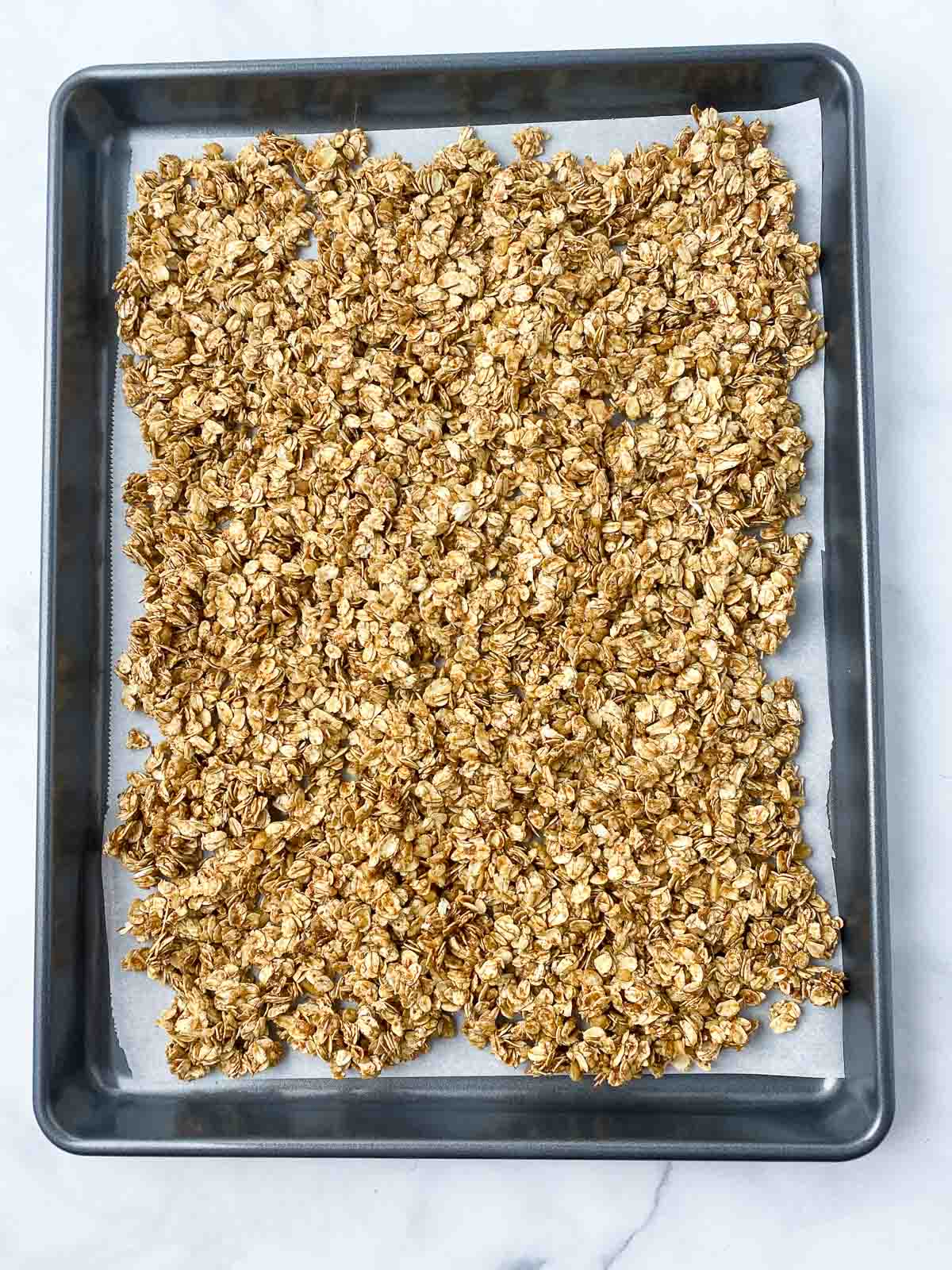 Unbaked granola on baking sheet.