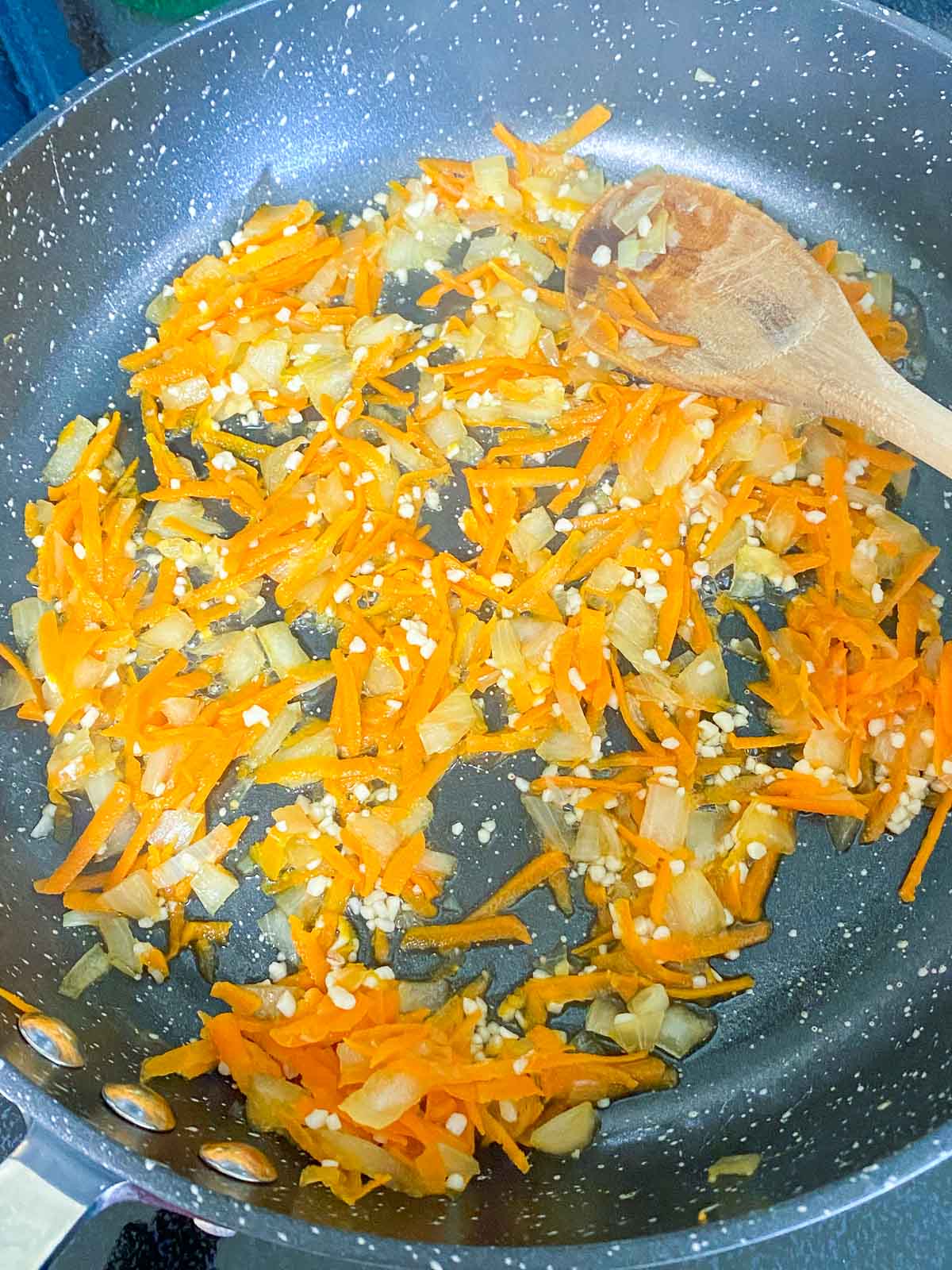 Garlic added to pan of sauteed onion and carrot.