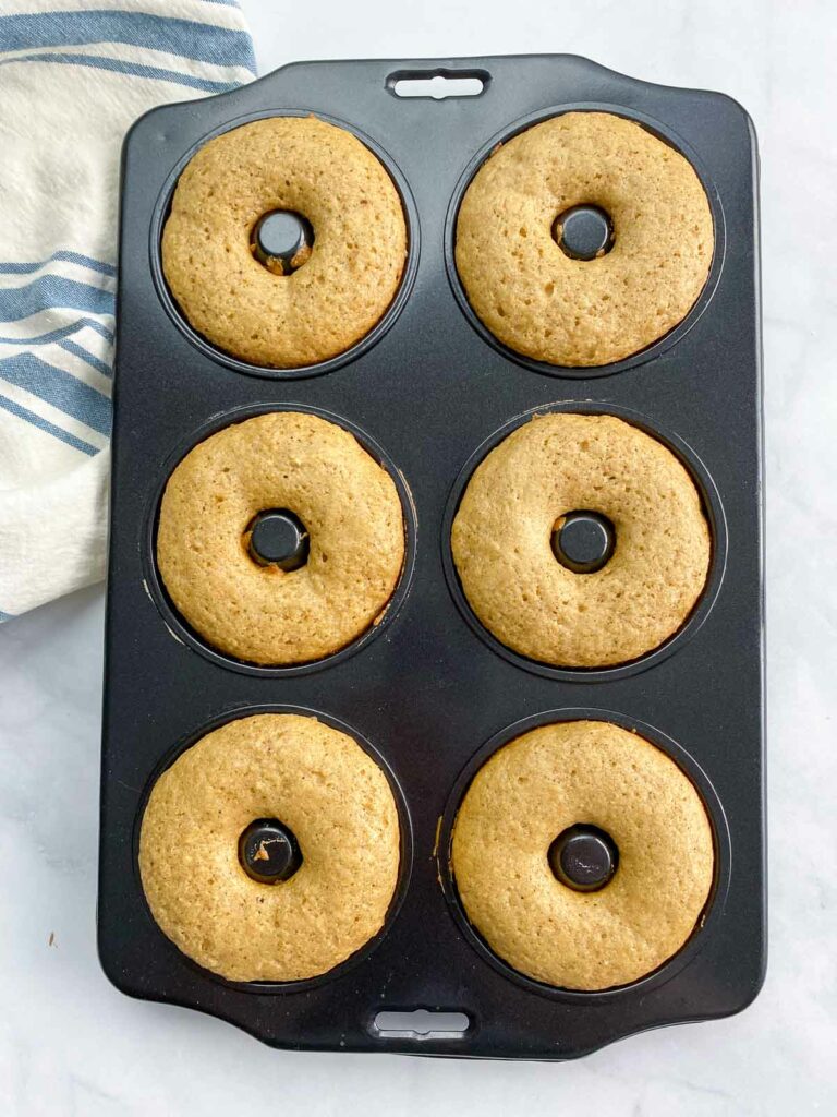 Baked vegan donuts in a donut pan.