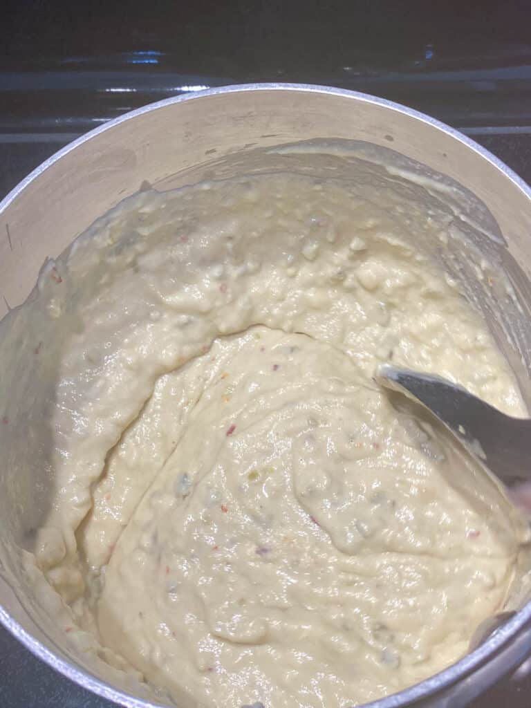 Vegan pepper jack cheese curdling as it begins to thicken.