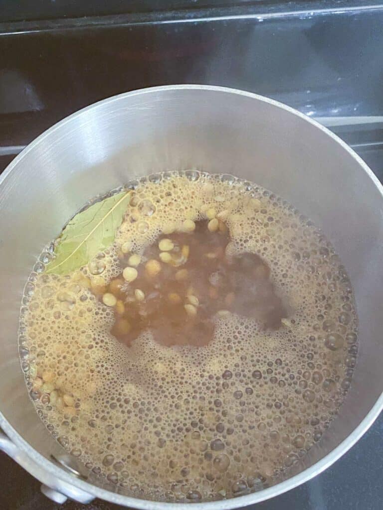 Lentils cooking in sauce pan.