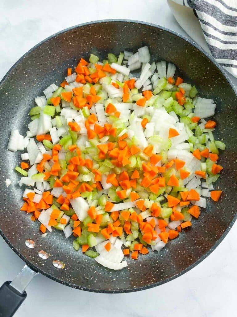Diced onions, celery, and carrots in a non-stick skillet.