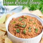 Image of refried beans surrounded by tortilla chips with Pinterest text.