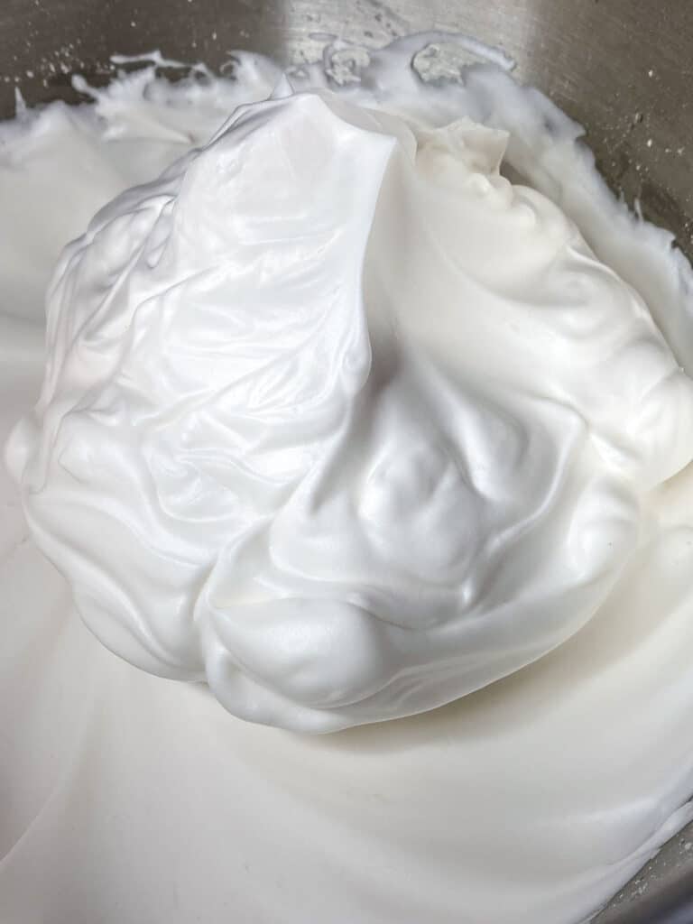 Aquafaba whipped cream in mixer bowl.