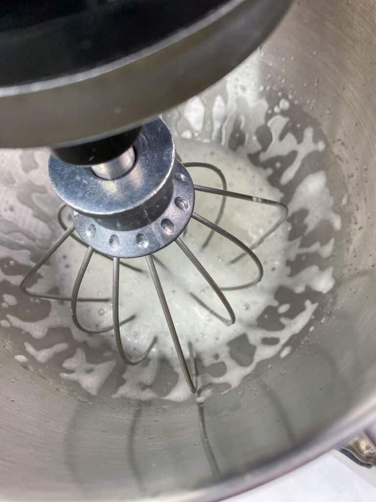 Aquafaba beginning to foam in mixer.