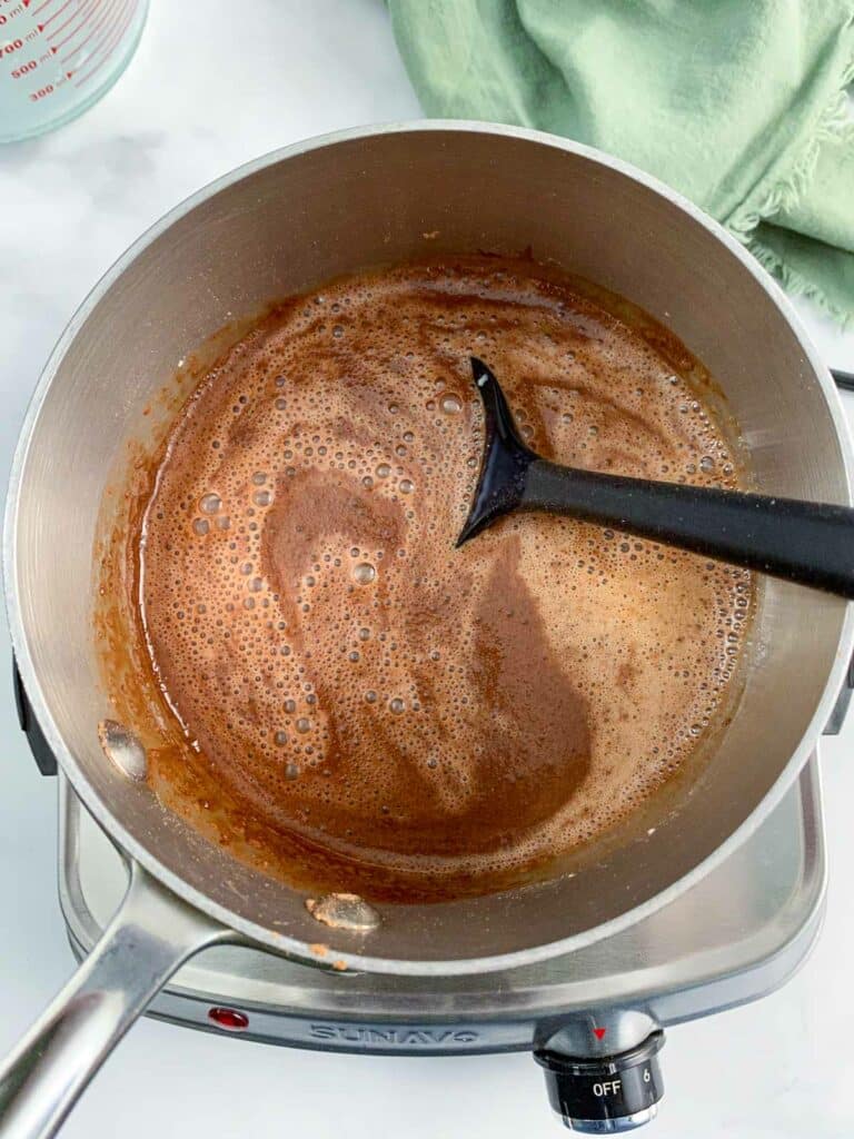 Uncooked pudding in a sauce pan.