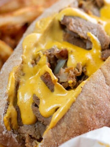 Closeup shot of vegan Philly cheesesteak sandwich.