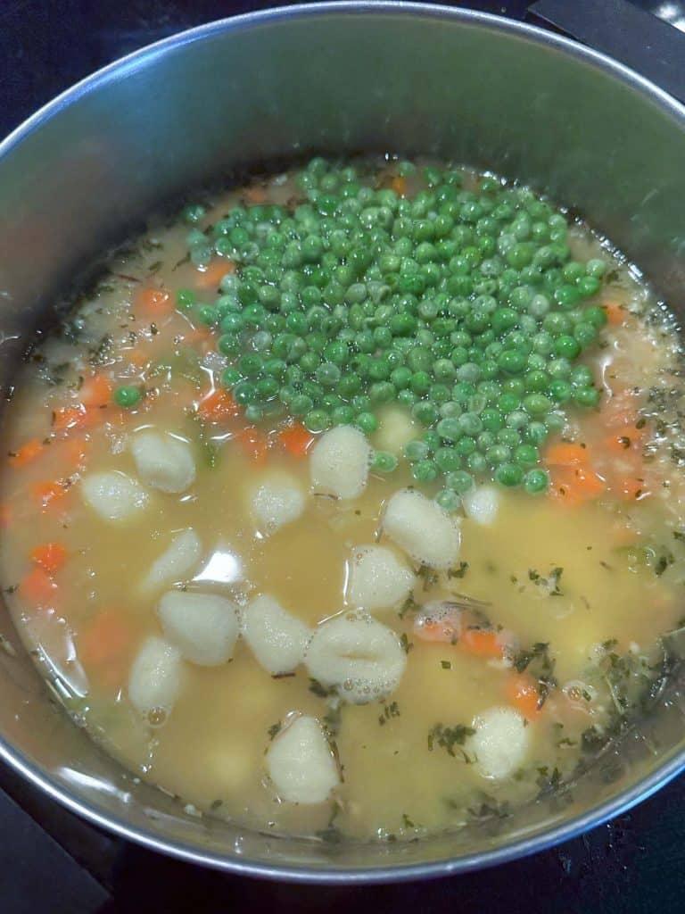 Gnocchi and peas added to the pot of soup.