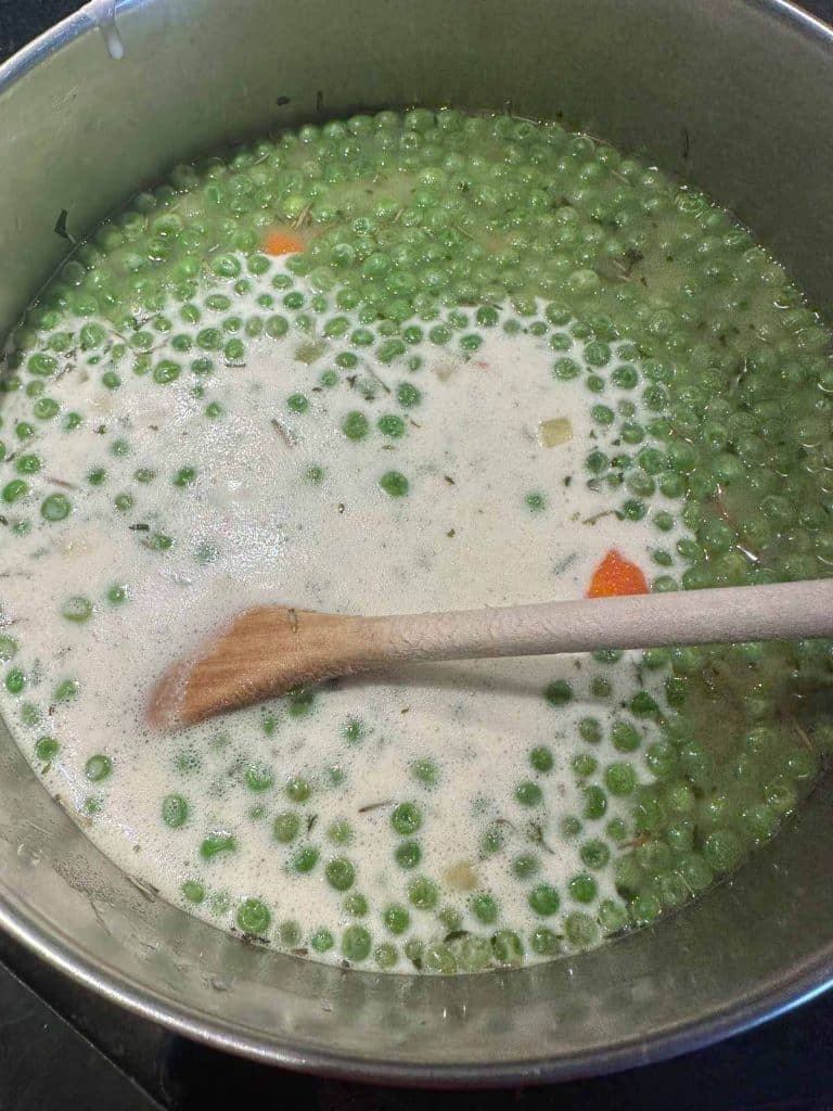 Soy cream added to the pot of soup.